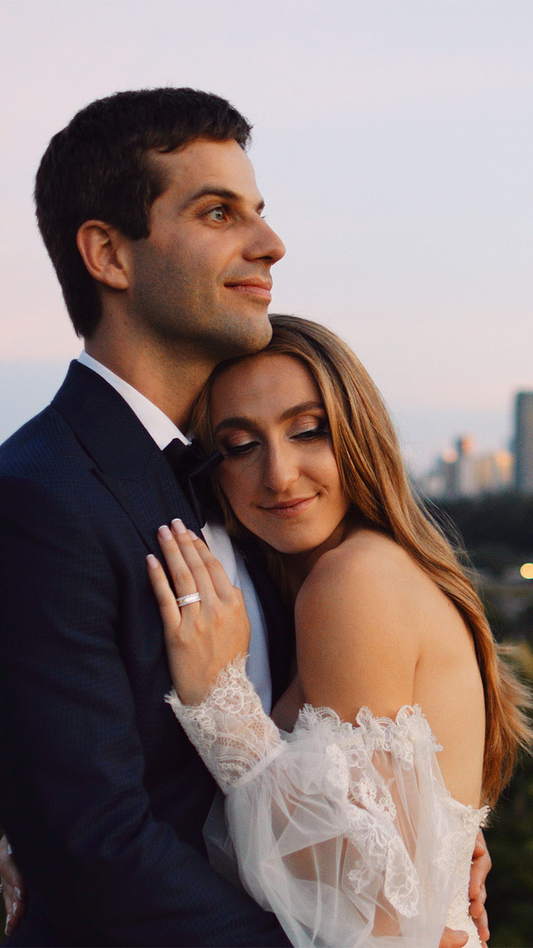 Emma and Mark overlooking the Toronto skyline at sunset on their Evergreen Brick Works wedding day